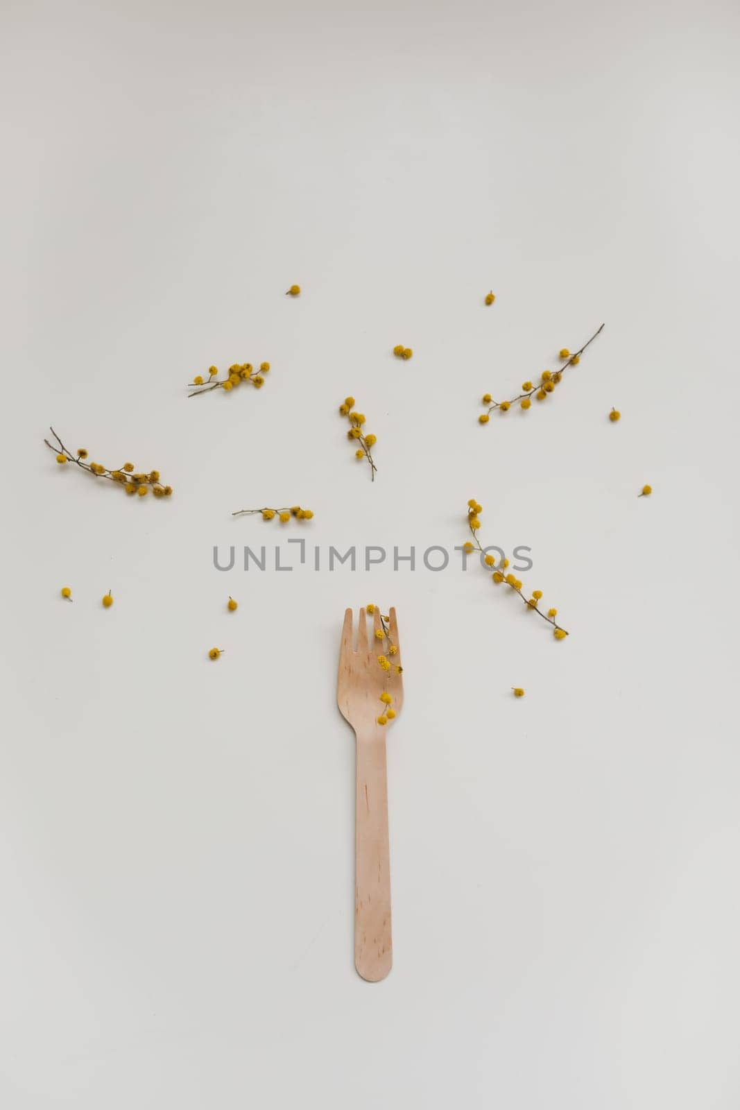 Cutlery with flowers on white textured background. Sustainable lifestyle, no plastic concept, zero waste