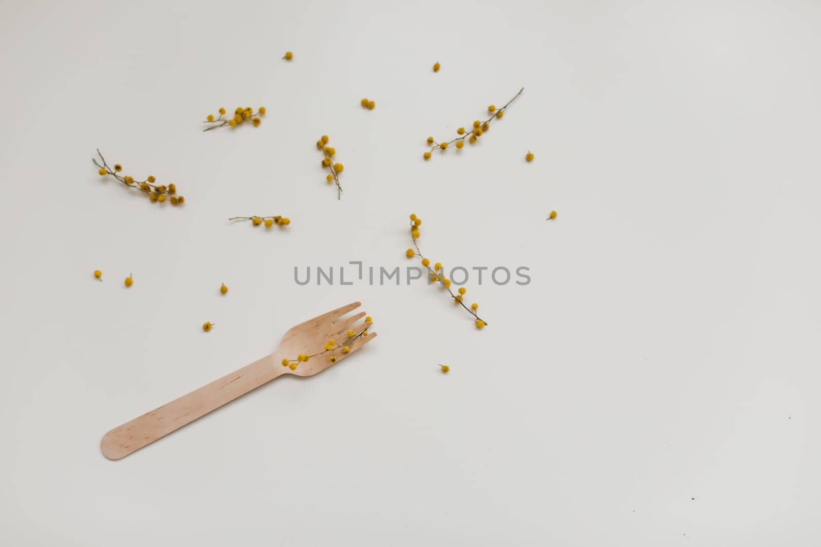 Cutlery with flowers on white textured background. Sustainable lifestyle, no plastic concept, zero waste
