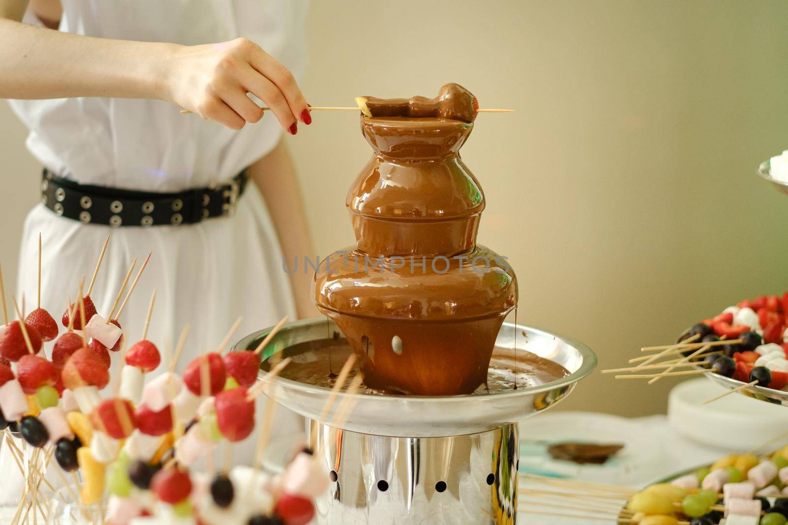 Fondue with a chocolate fountain and sweets for it.Sweet theme.
