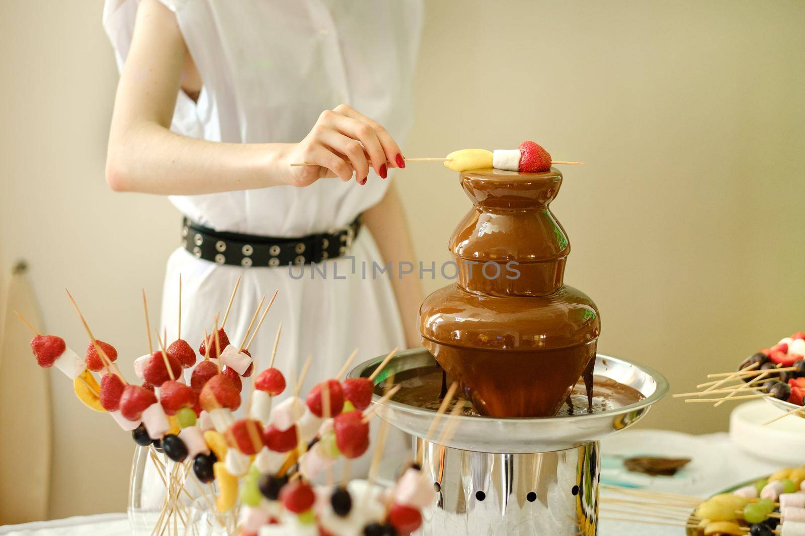 Fondue with a chocolate fountain and sweets for it.Sweet theme.