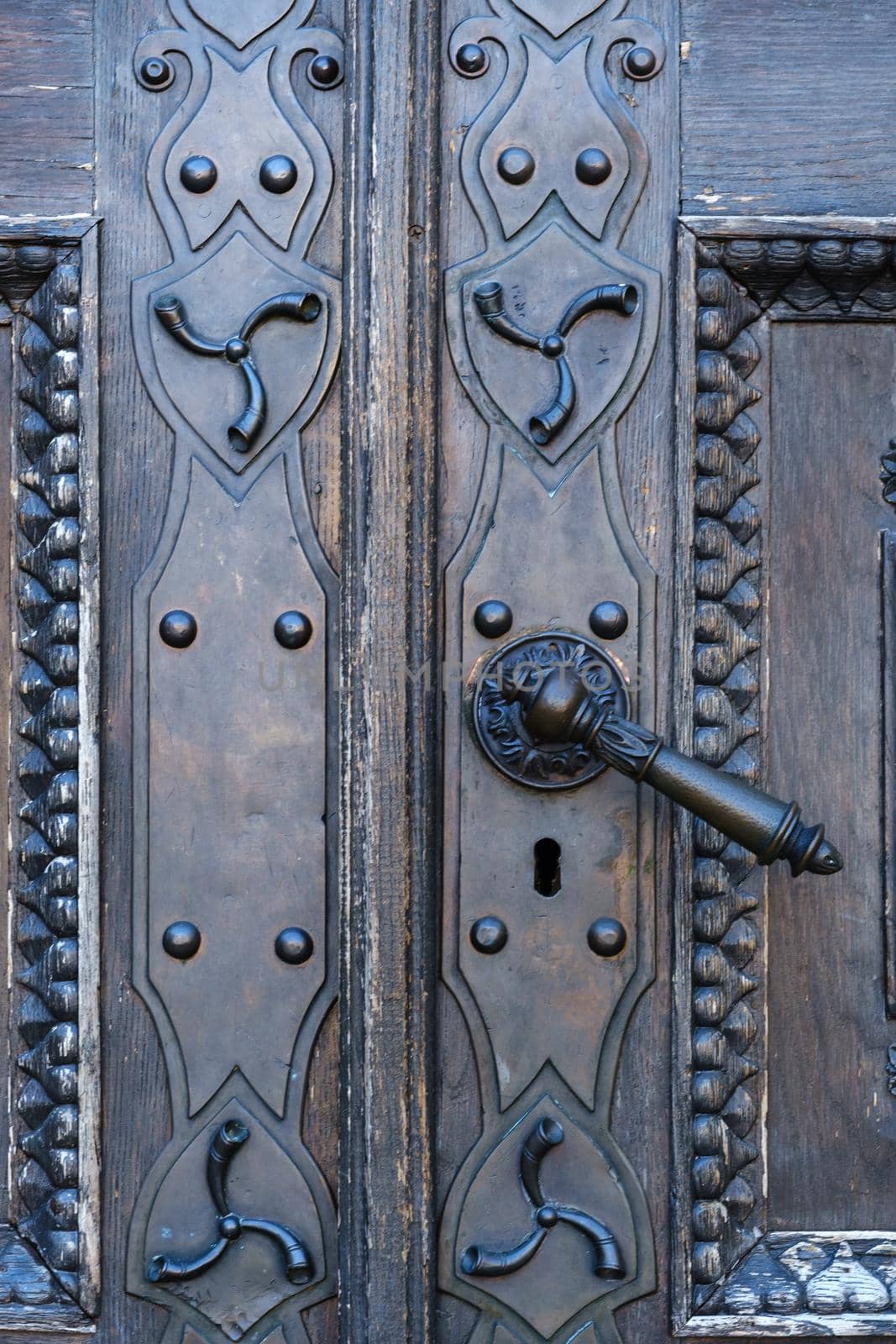 Old metal door handle on the old door.