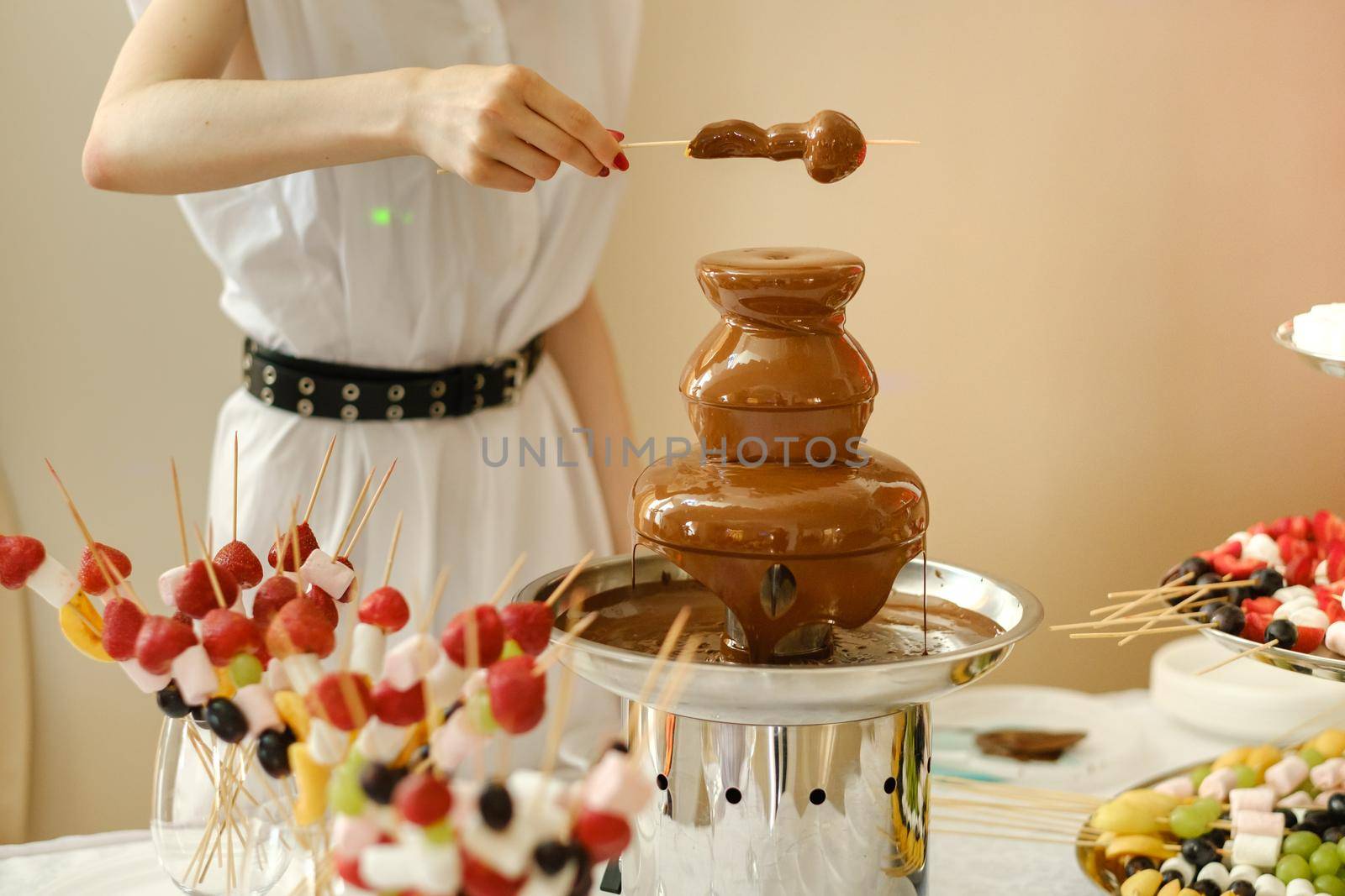 Fondue with a chocolate fountain and sweets for it.Sweet theme.