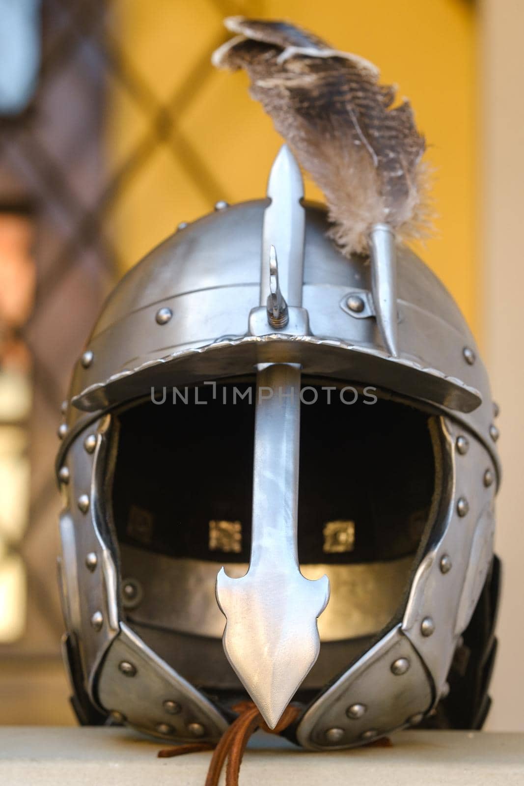 An ancient knight's helmet with a feather .Medieval concept.
