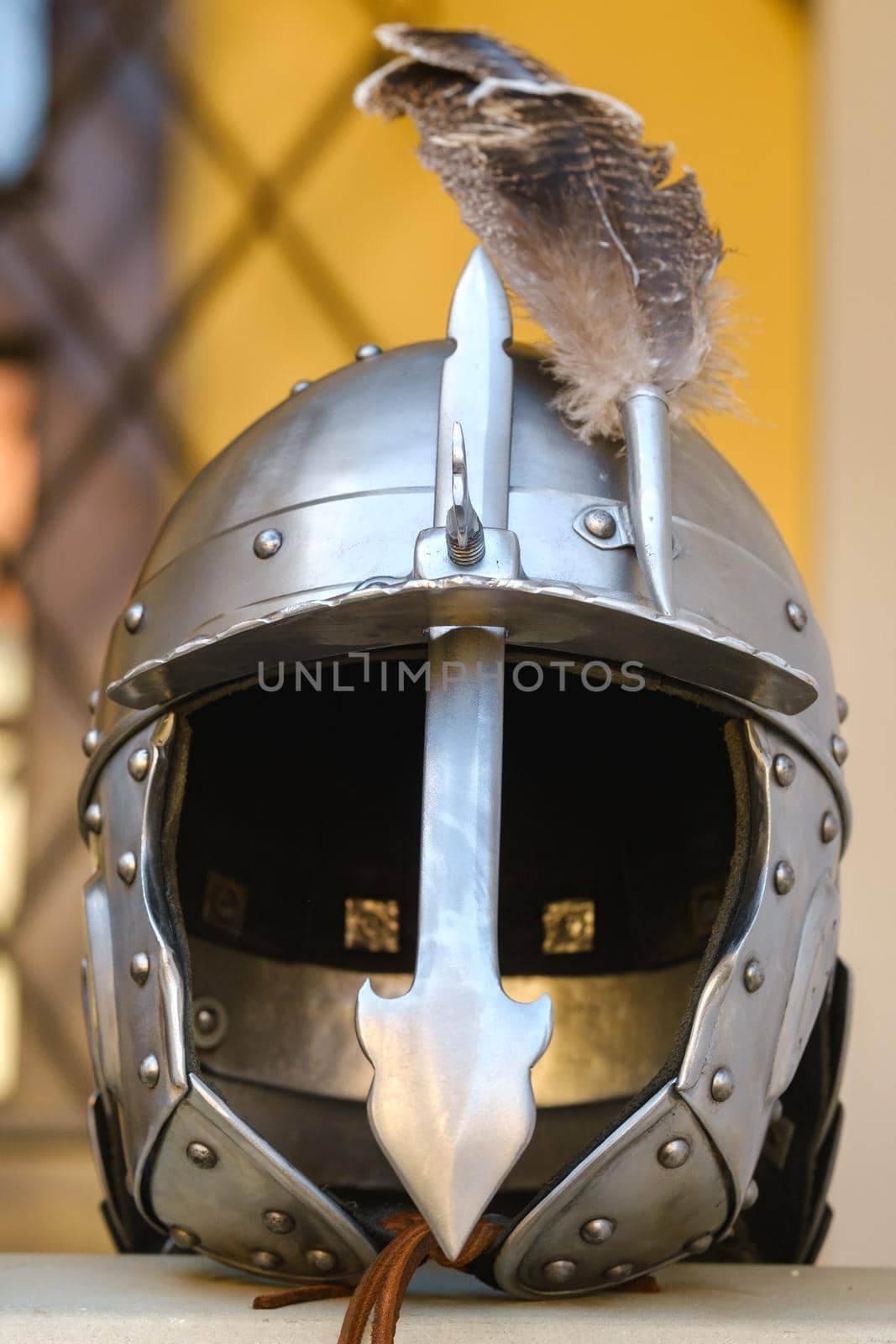 An ancient knight's helmet with a feather .Medieval concept by Lobachad