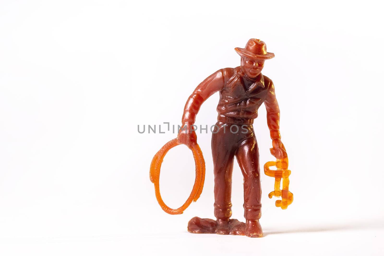 Vintage toy brown cowboy isolated on white background.