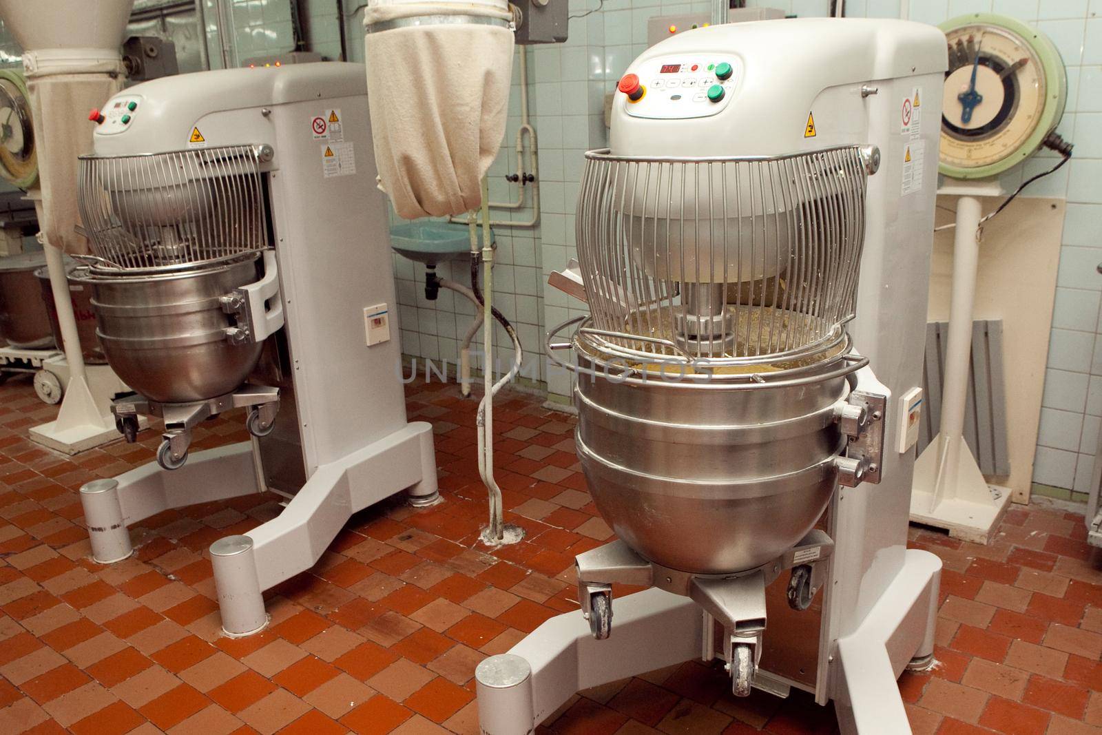 The process of making cookie dough in an industrial kneading machine at the factory.