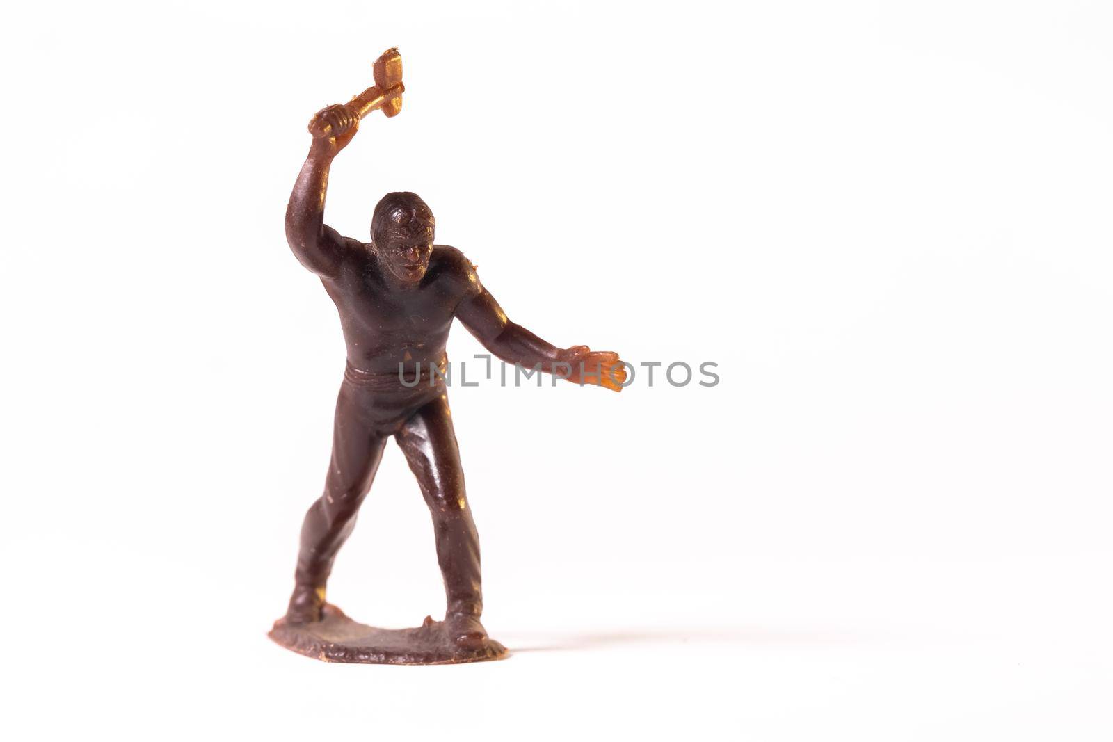 Large toy figures of primitive people on a white background.