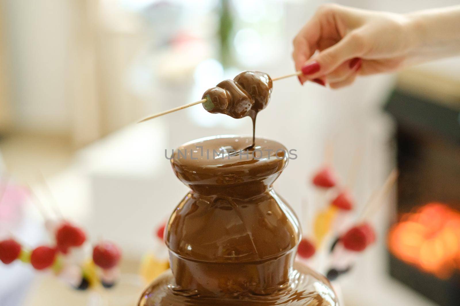 Fondue with a chocolate fountain and sweets for it.Sweet theme.