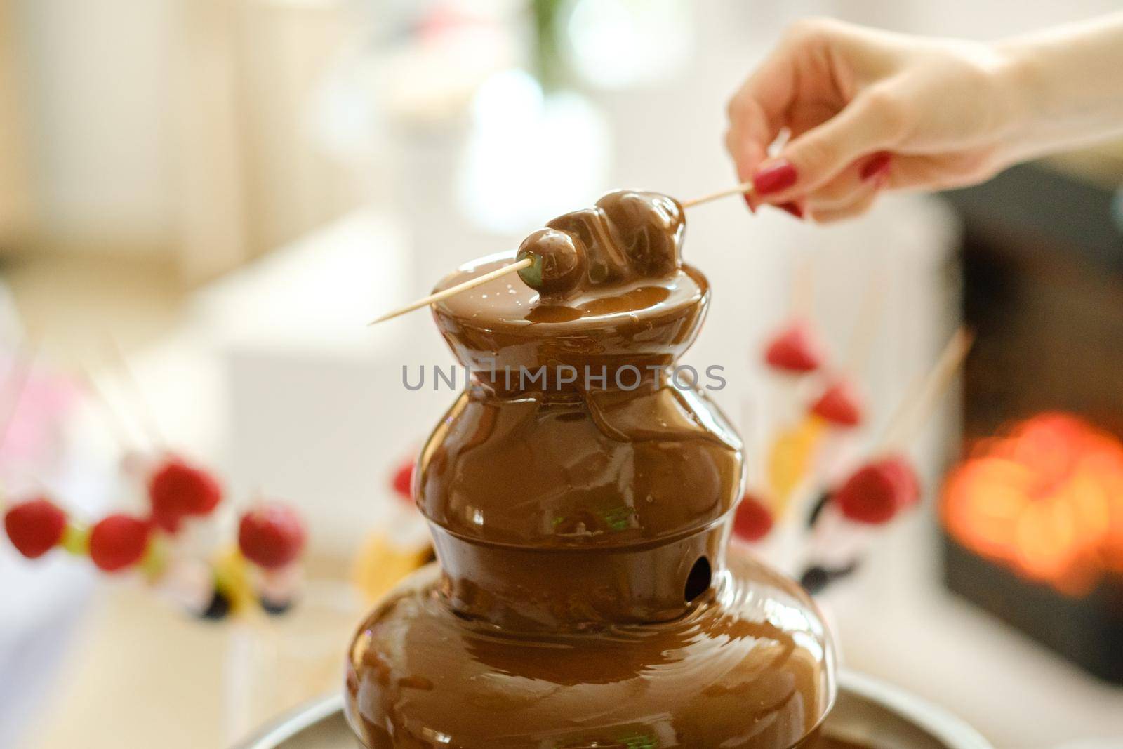 Fondue with a chocolate fountain and sweets for it.Sweet theme.