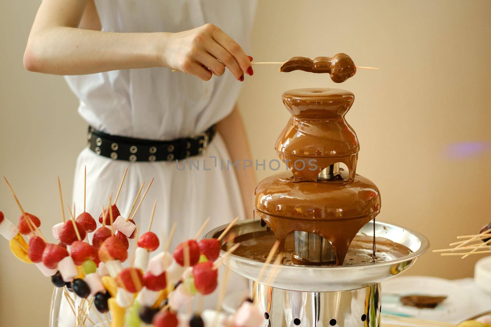 Fondue with a chocolate fountain and sweets for it.Sweet theme.