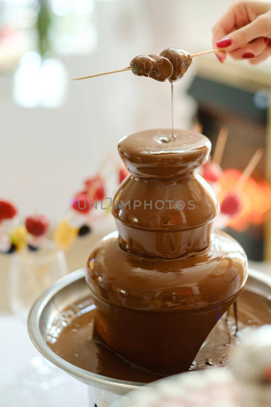 Fondue with a chocolate fountain and sweets for it.Sweet theme.