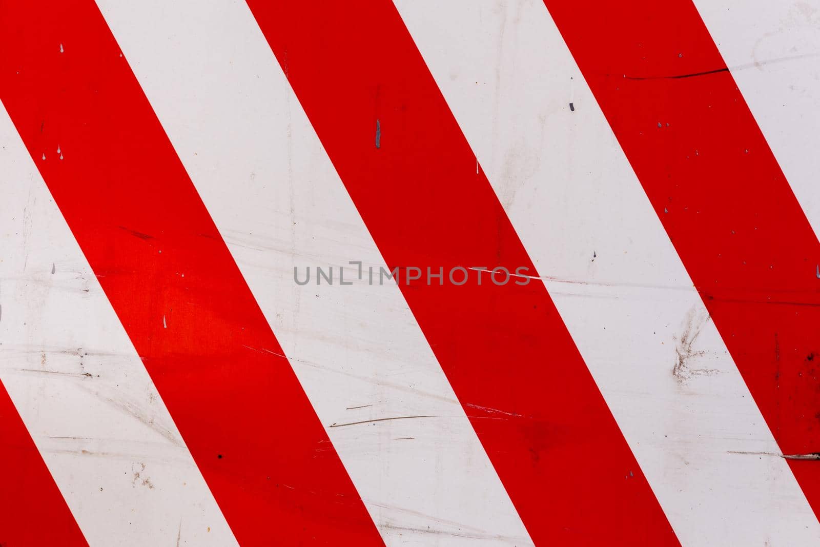 faded red and white diagonal stipes on flat steel sheet - caution road sign