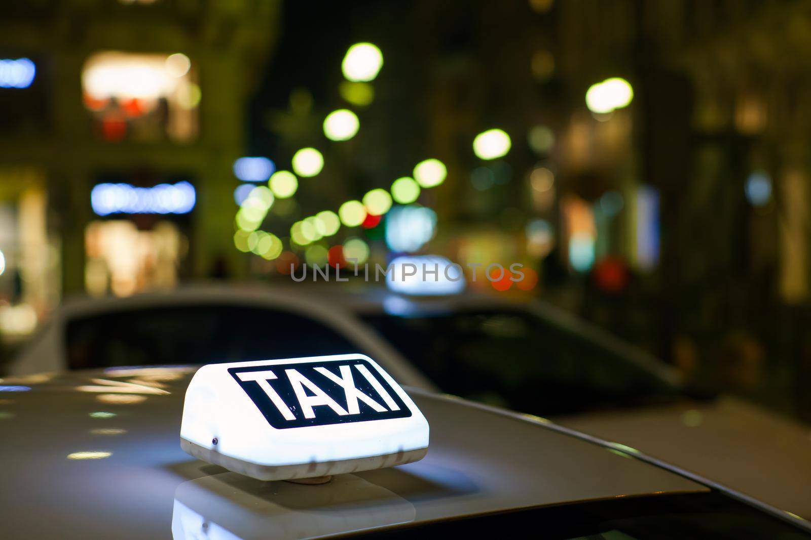 Taxi sign from parked taxi in the Milan street at night