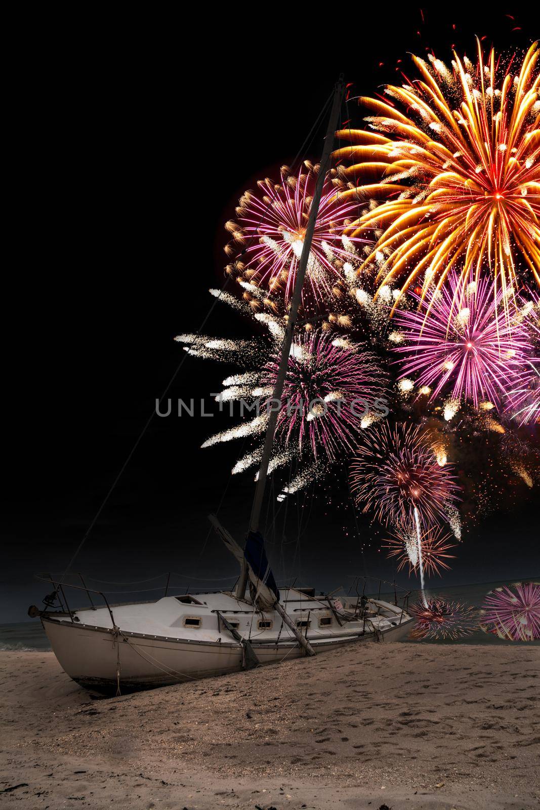 Fireworks in the night sky over a shipwreck off the coast of Clam Pass in Naples, Florida