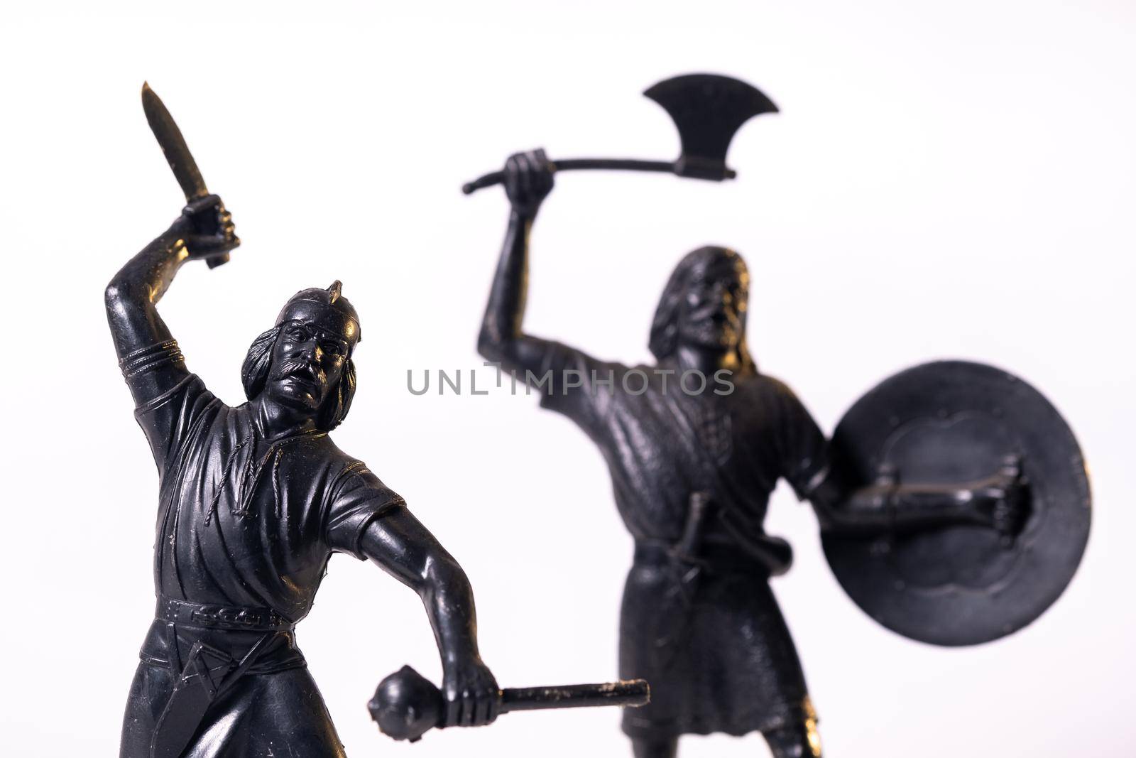 Vintage toys black Viking soldiers isolated on white background.