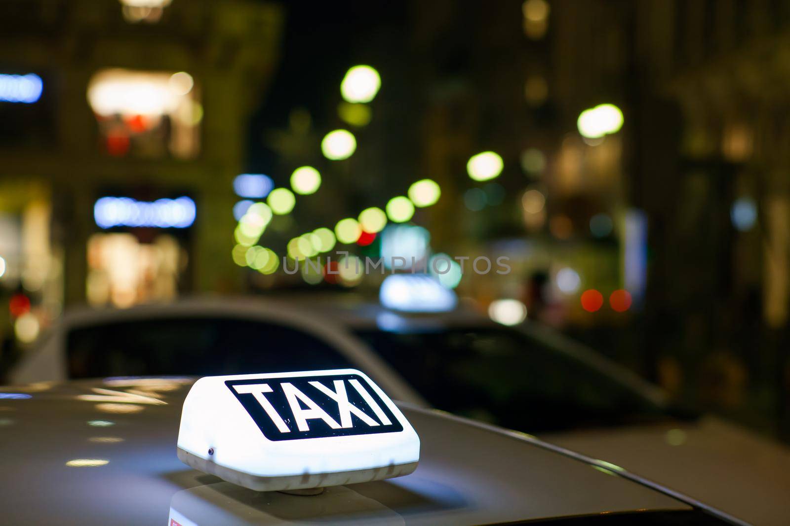 Taxi sign from parked taxi in the Milan street at night