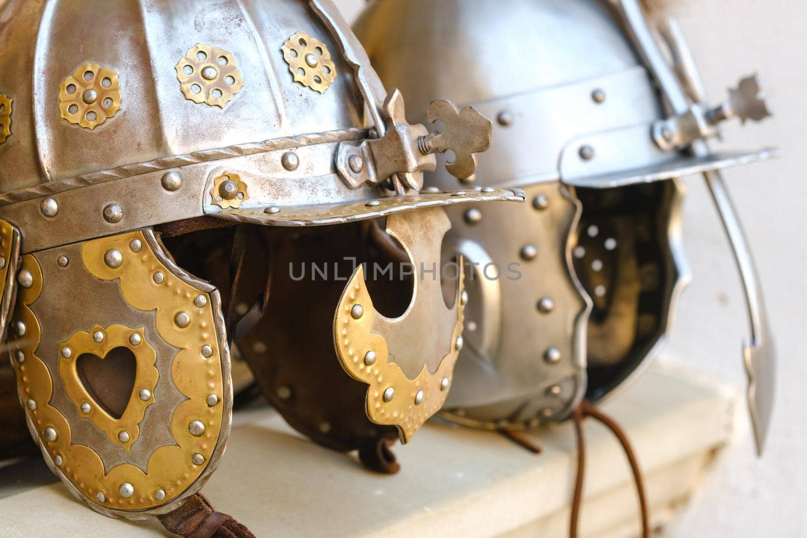 Two knight's helmets are lying on the surface.Medieval concept.