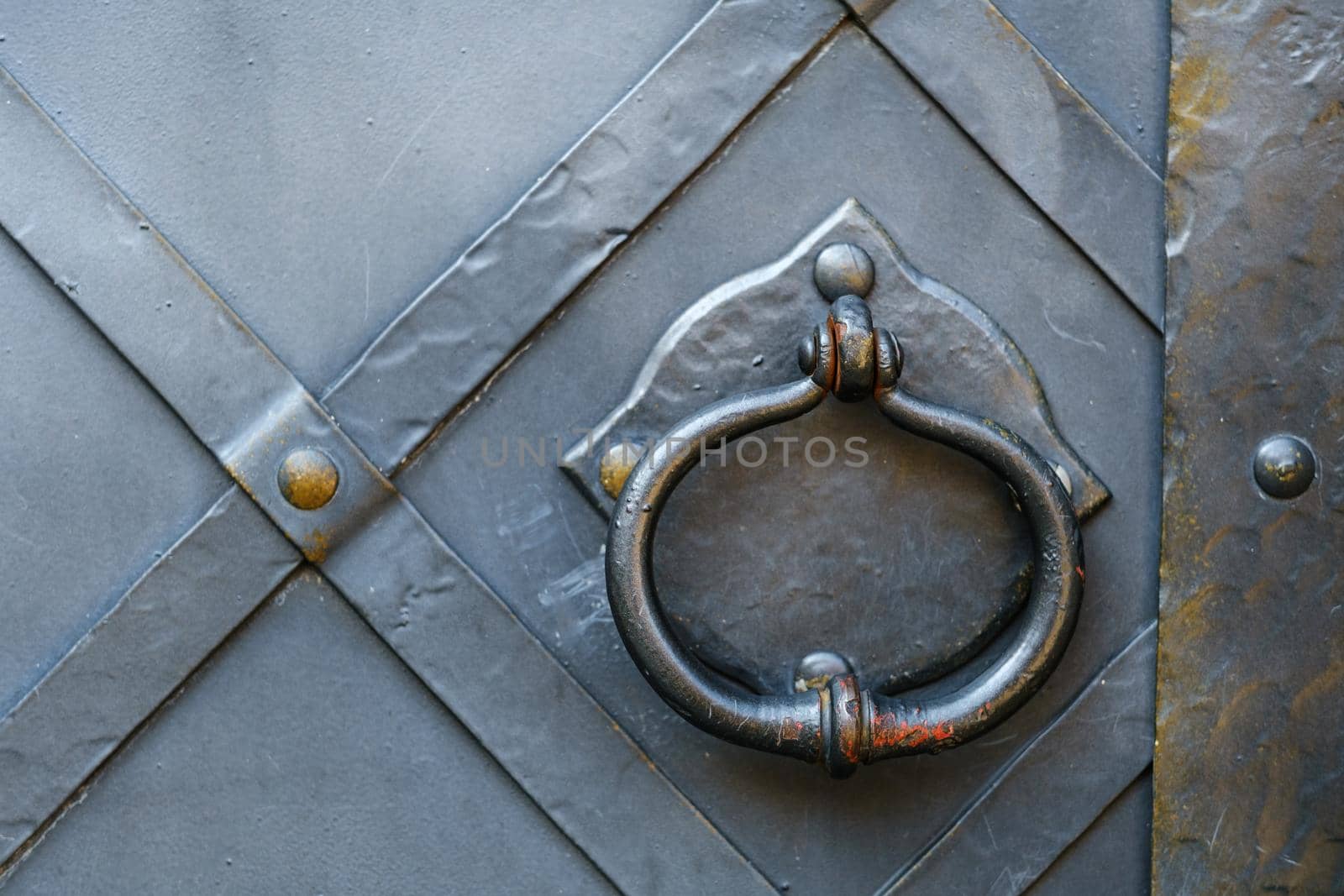 Old metal door handle on the old door.