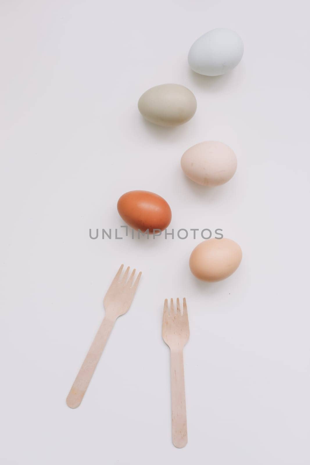 Chicken eggs of natural shades and colors a white background. Healthy organic food, natural farmer's products concept. Happy Easter background. Selective focus.