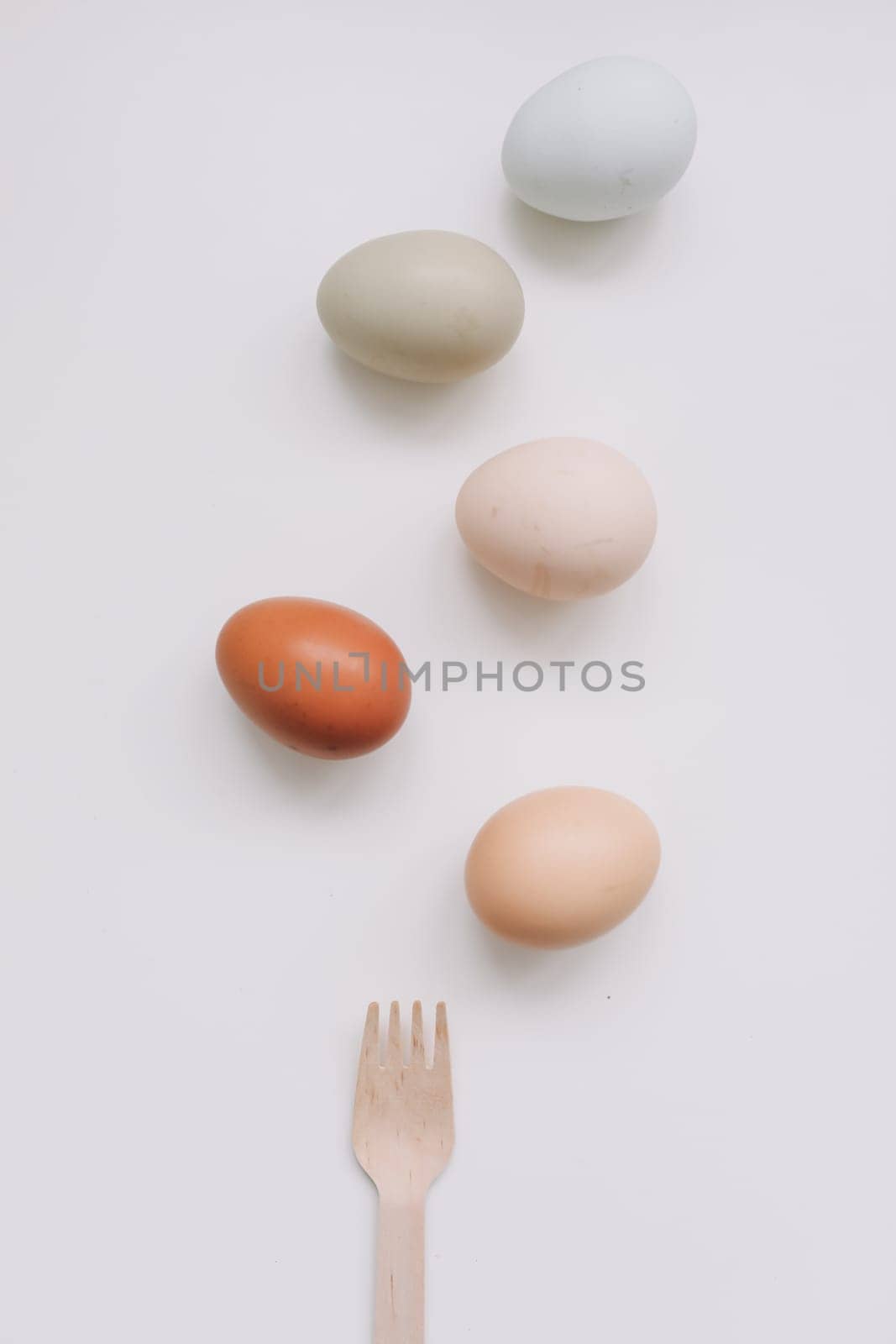 Chicken eggs of natural shades and colors a white background. Healthy organic food, natural farmer's products concept. Happy Easter background. Selective focus.
