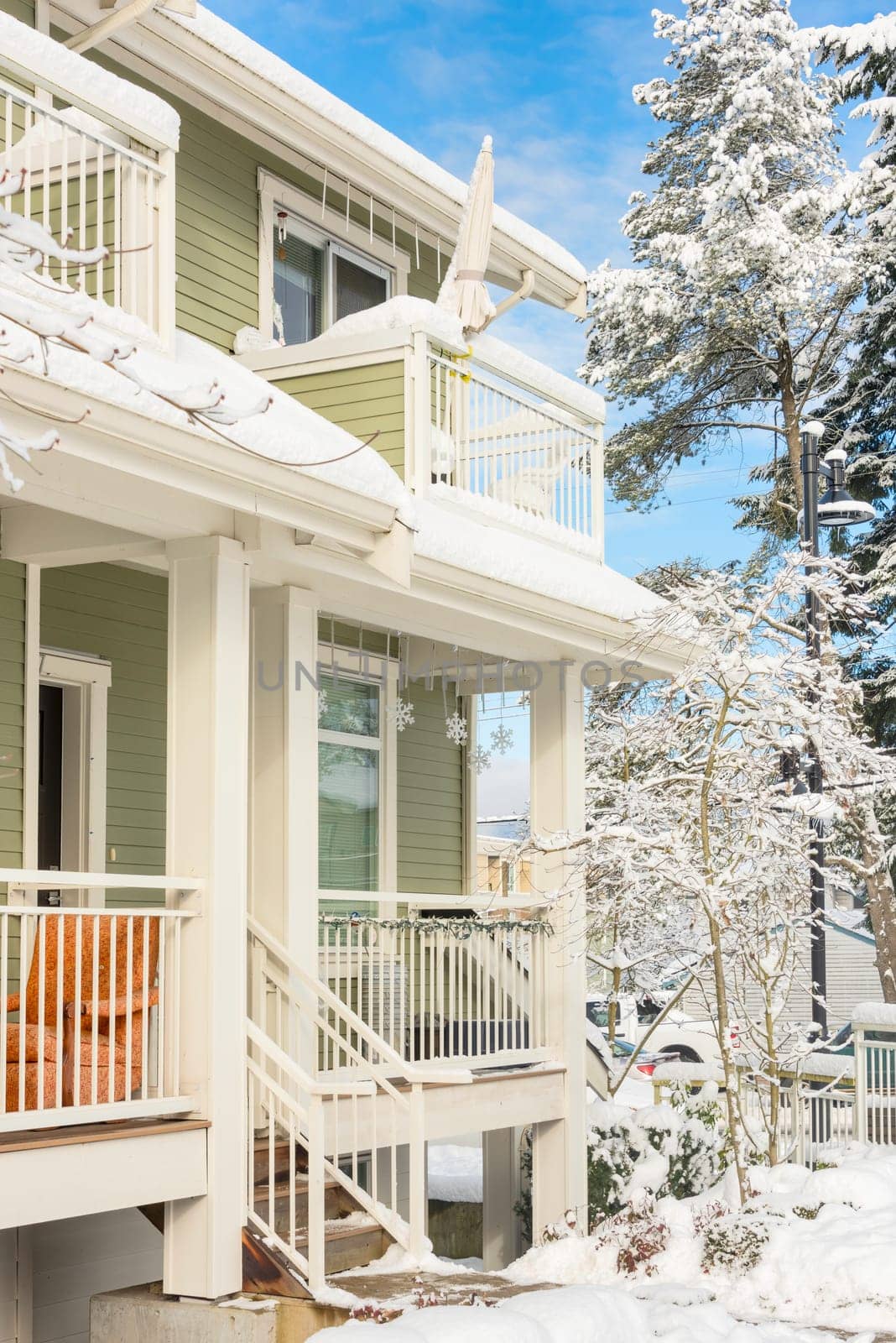 Residential townhouses and high-rise building on bright winter day by Imagenet