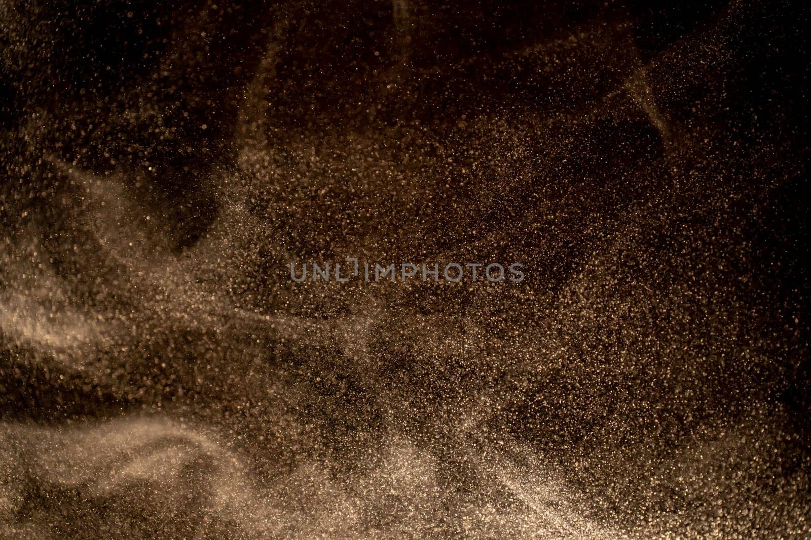 Dust particles cloud generating abstract shape on black background with copy space for text. by PaulCarr