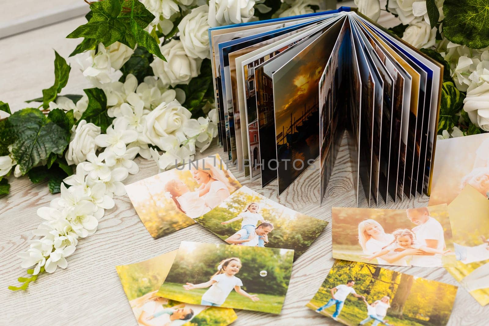 Family photos archive saved in brightly designed photo book; bright summer memories placed in the photobook