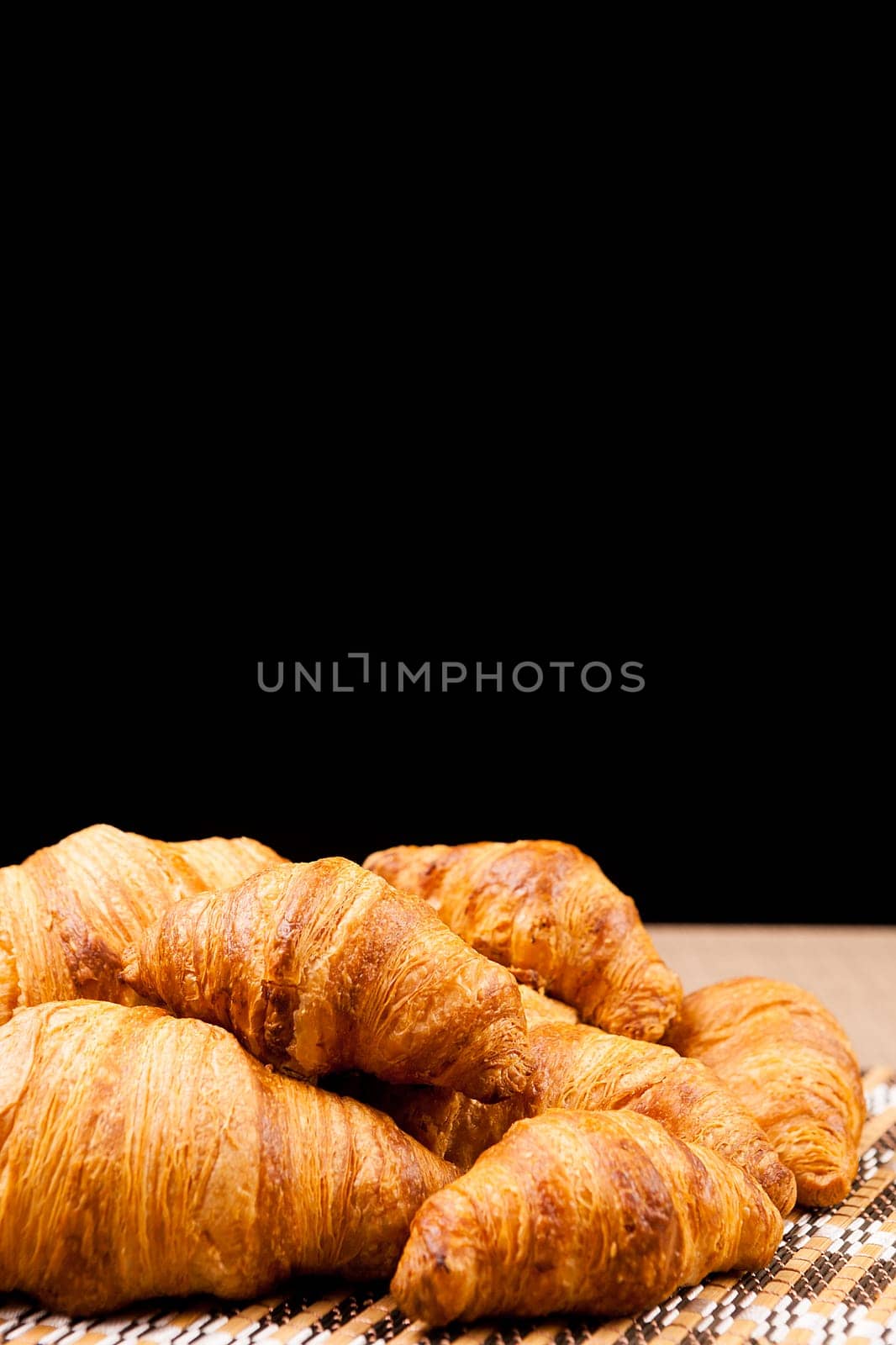 Freshly baked croissants lying on a table by DCStudio