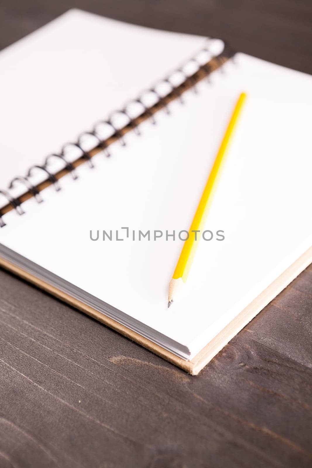 Open notebook with a pencil in it by DCStudio