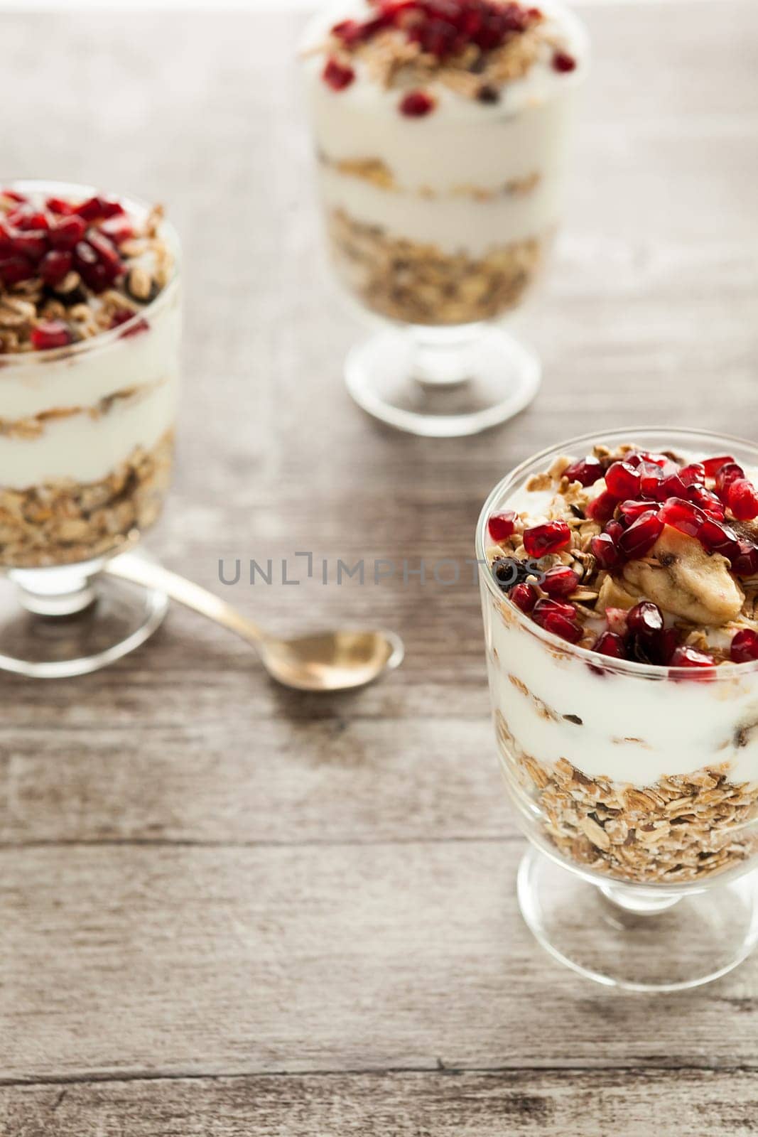 Healthy muesli with oatmeal, yoghurt and pomegranate by DCStudio