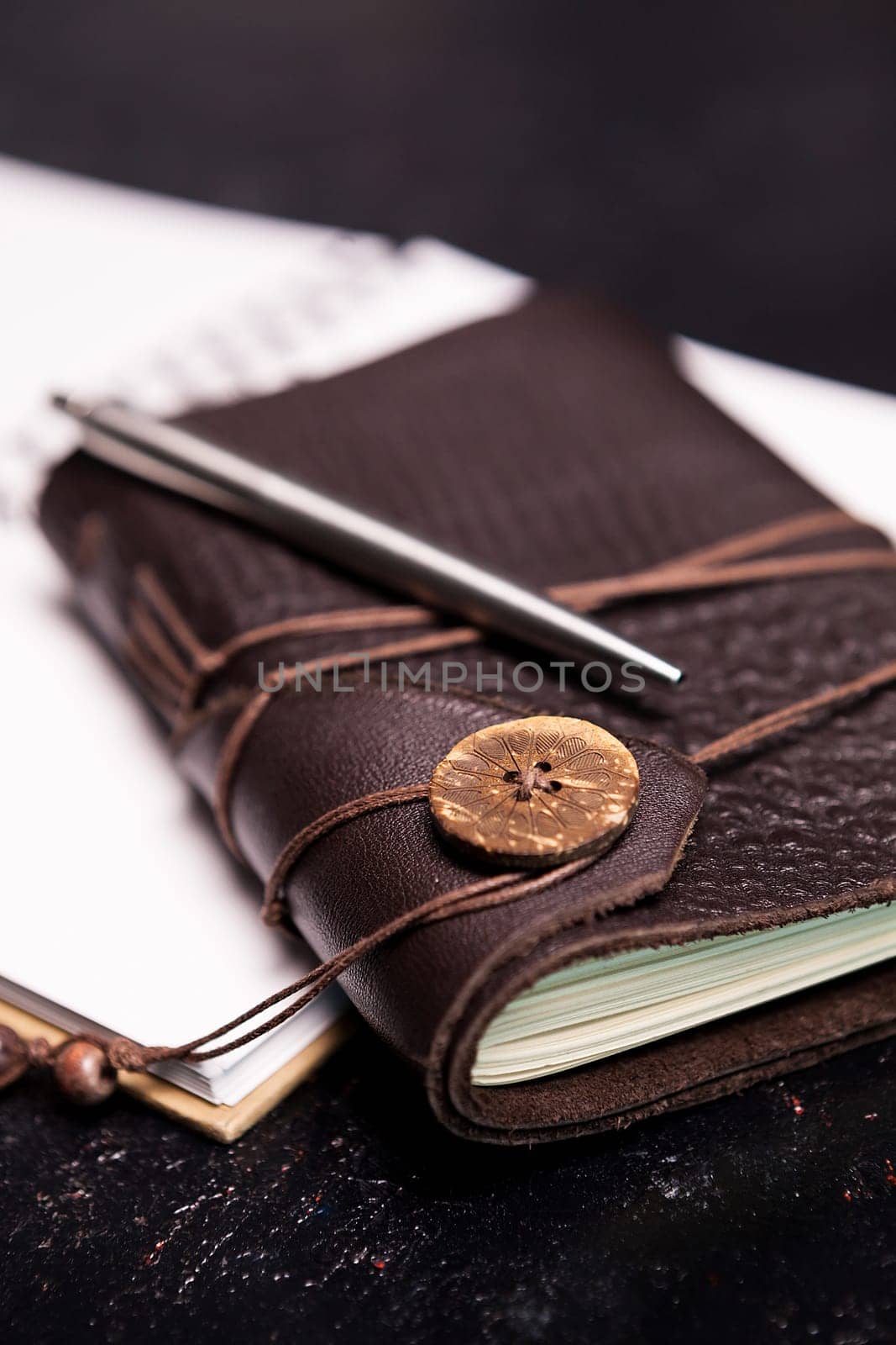 Leather covered vintage ntoebook on an open diary by DCStudio