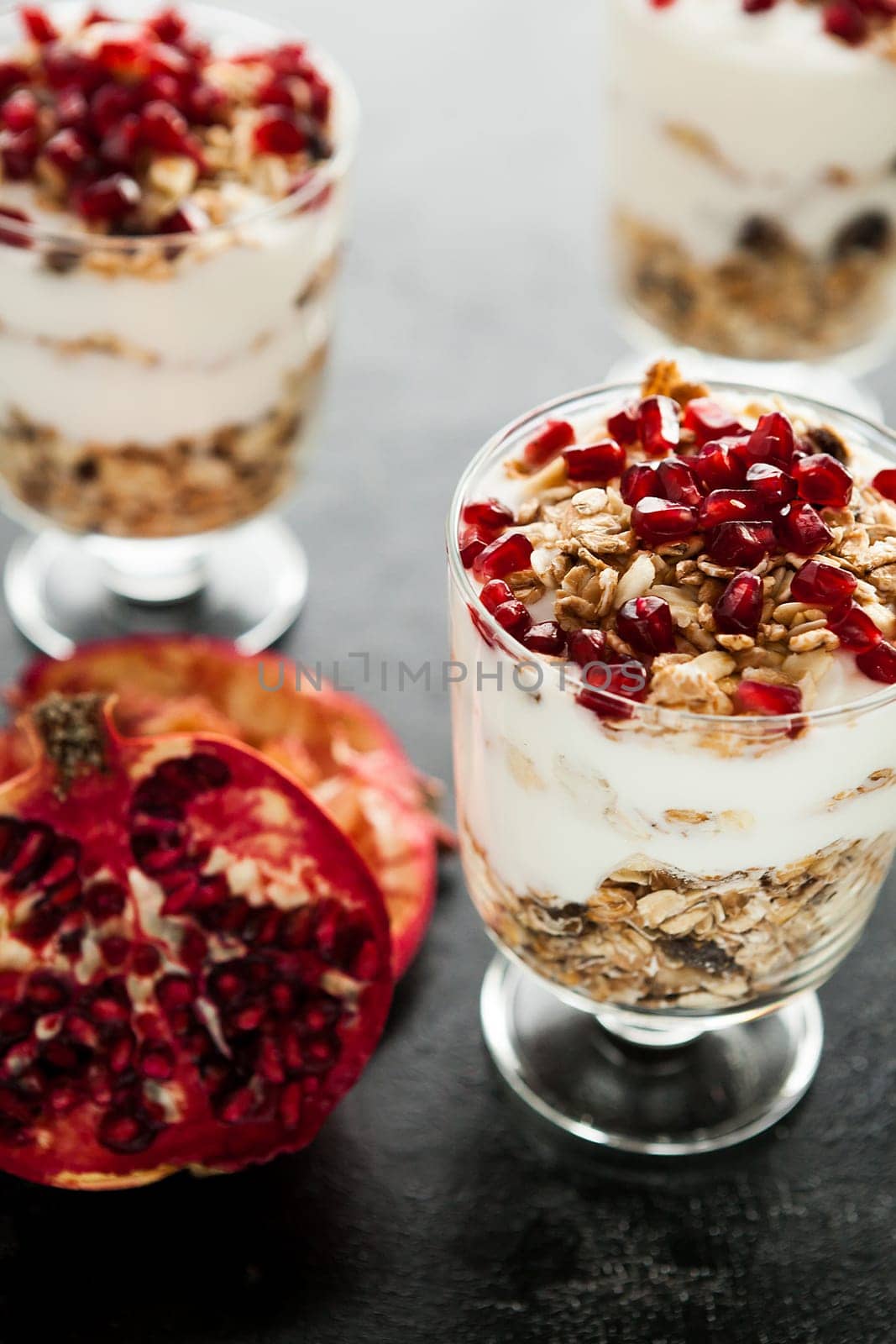 Fresh healthy home-made desset with muesli and pomegranate by DCStudio