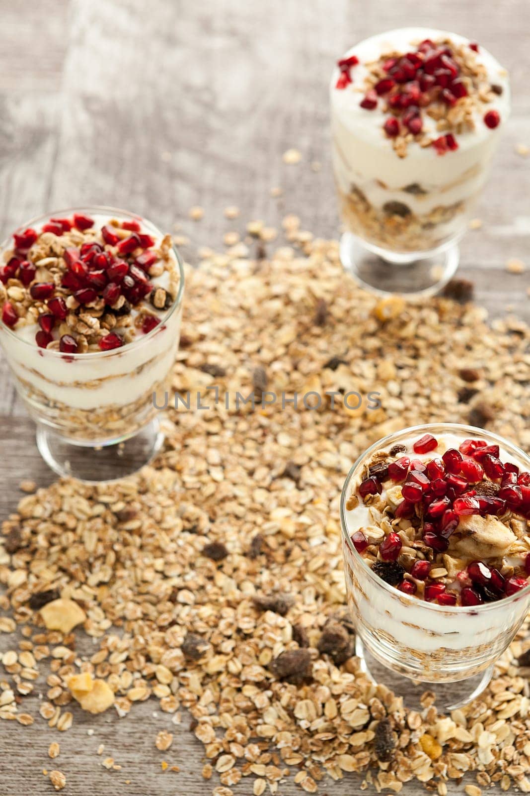 Muesli with oatmeal and pomegranate on top by DCStudio