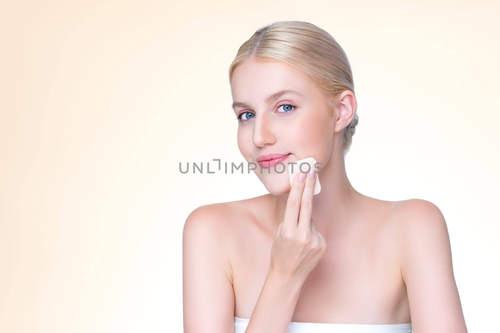 Personable beautiful natural soft makeup woman using powder puff for facial makeup concept. Cushion foundation applying on young girl face in isolated background.