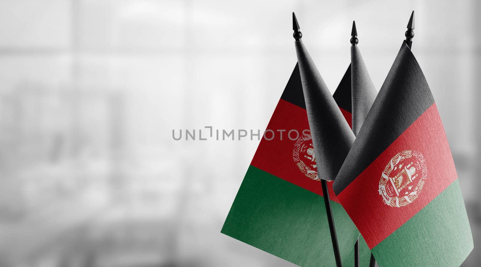 A small Afghanistan flag on an abstract blurry background.