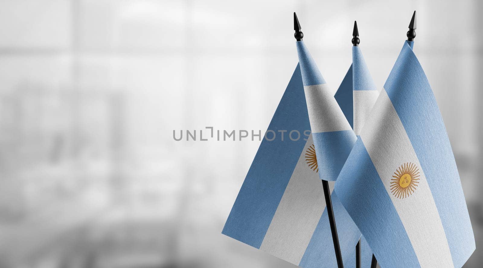 A small Argentina flag on an abstract blurry background.
