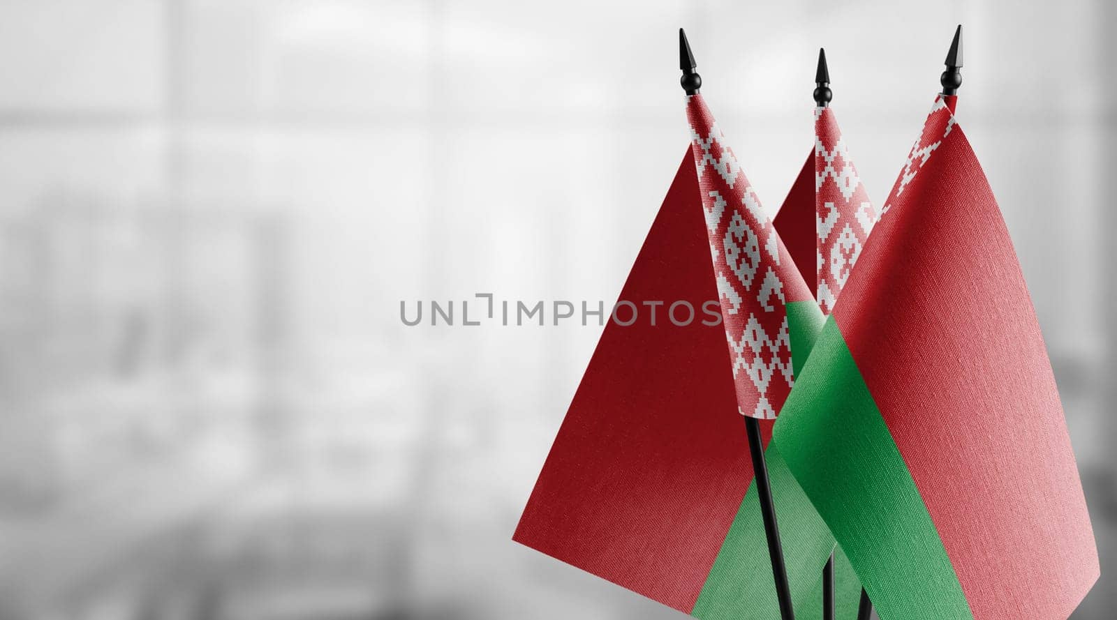 A small Belarus flag on an abstract blurry background.