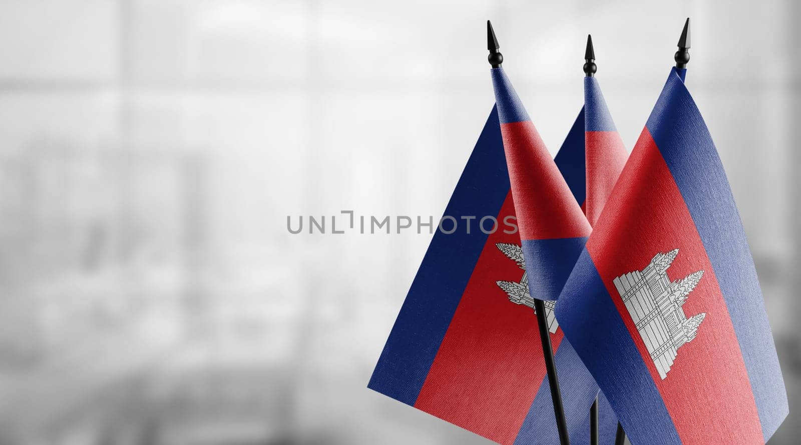 A small Cambodia flag on an abstract blurry background.