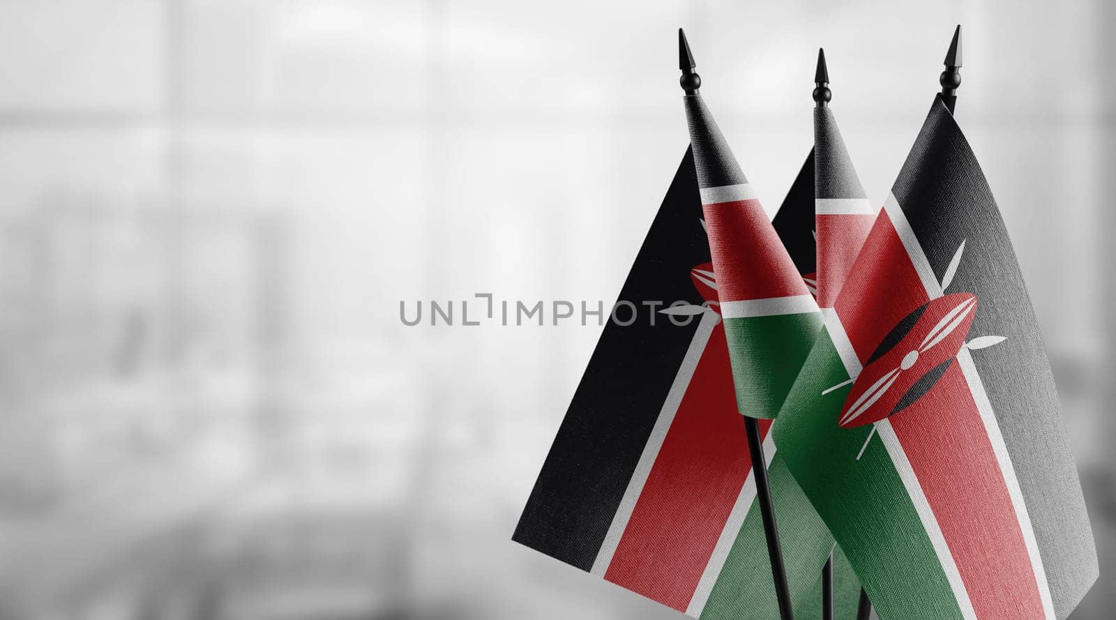 Small flags of the Kenya on an abstract blurry background.