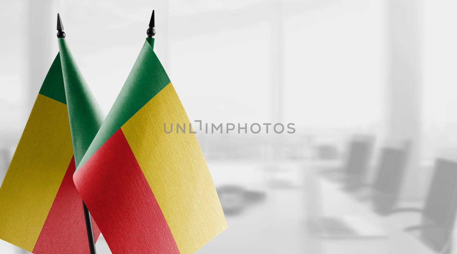 Small flags of the Benin on an abstract blurry background by butenkow