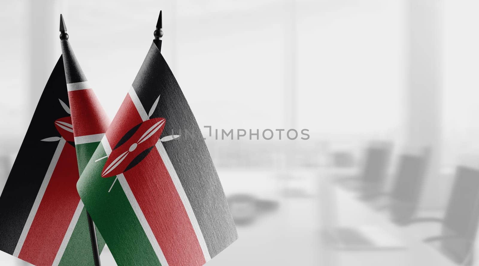 Small flags of the Kenya on an abstract blurry background.