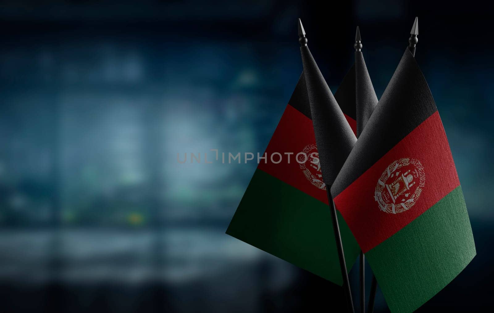 A small Afghanistan flag on an abstract blurry background.