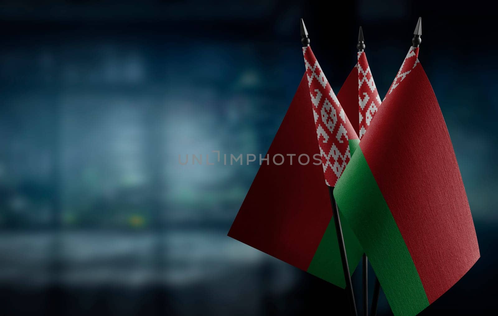 A small Belarus flag on an abstract blurry background.