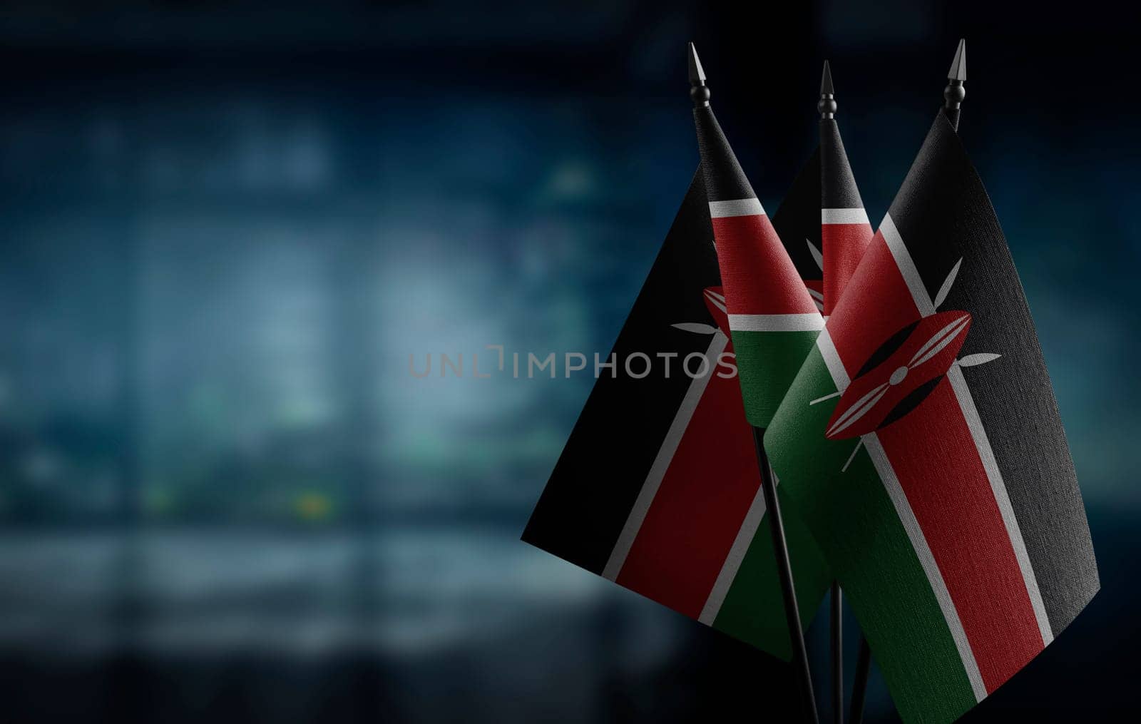 Small flags of the Kenya on an abstract blurry background.