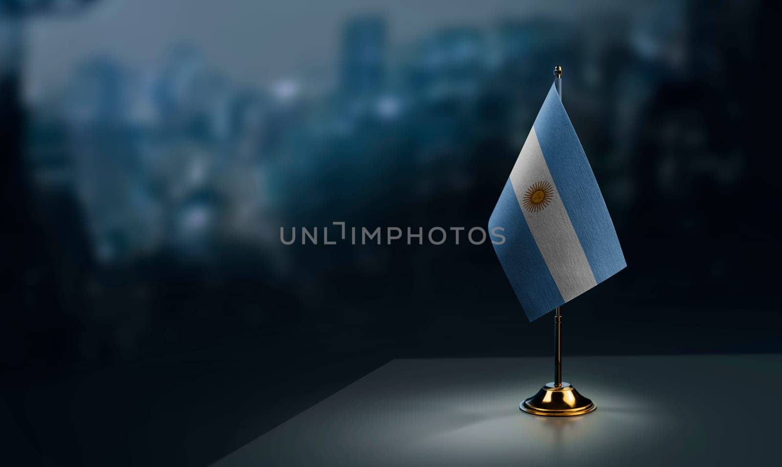 A small Argentina flag on an abstract blurry background.