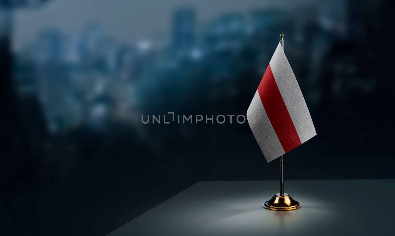 A small Belarus flag on an abstract blurry background.