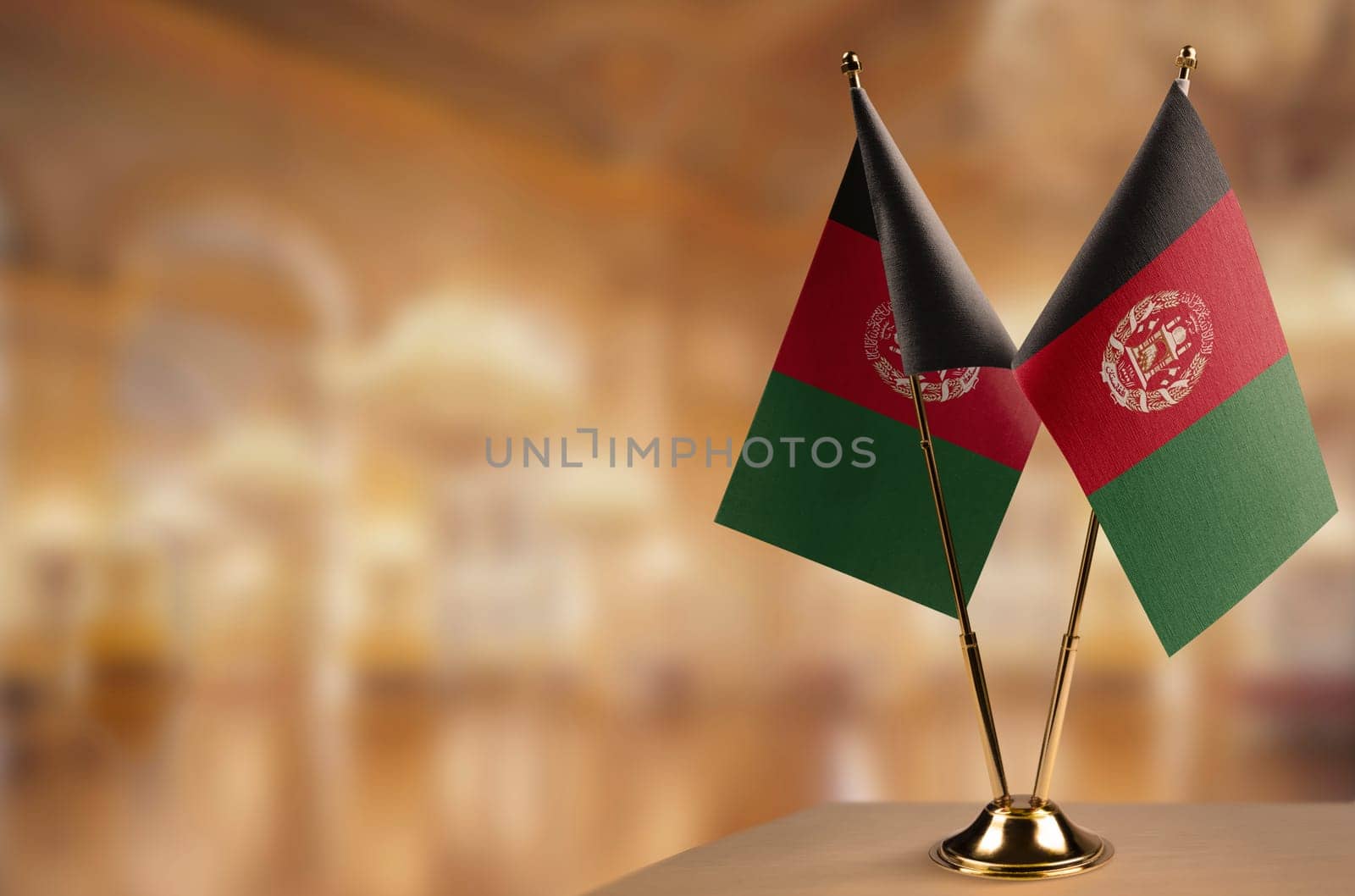 A small Afghanistan flag on an abstract blurry background.
