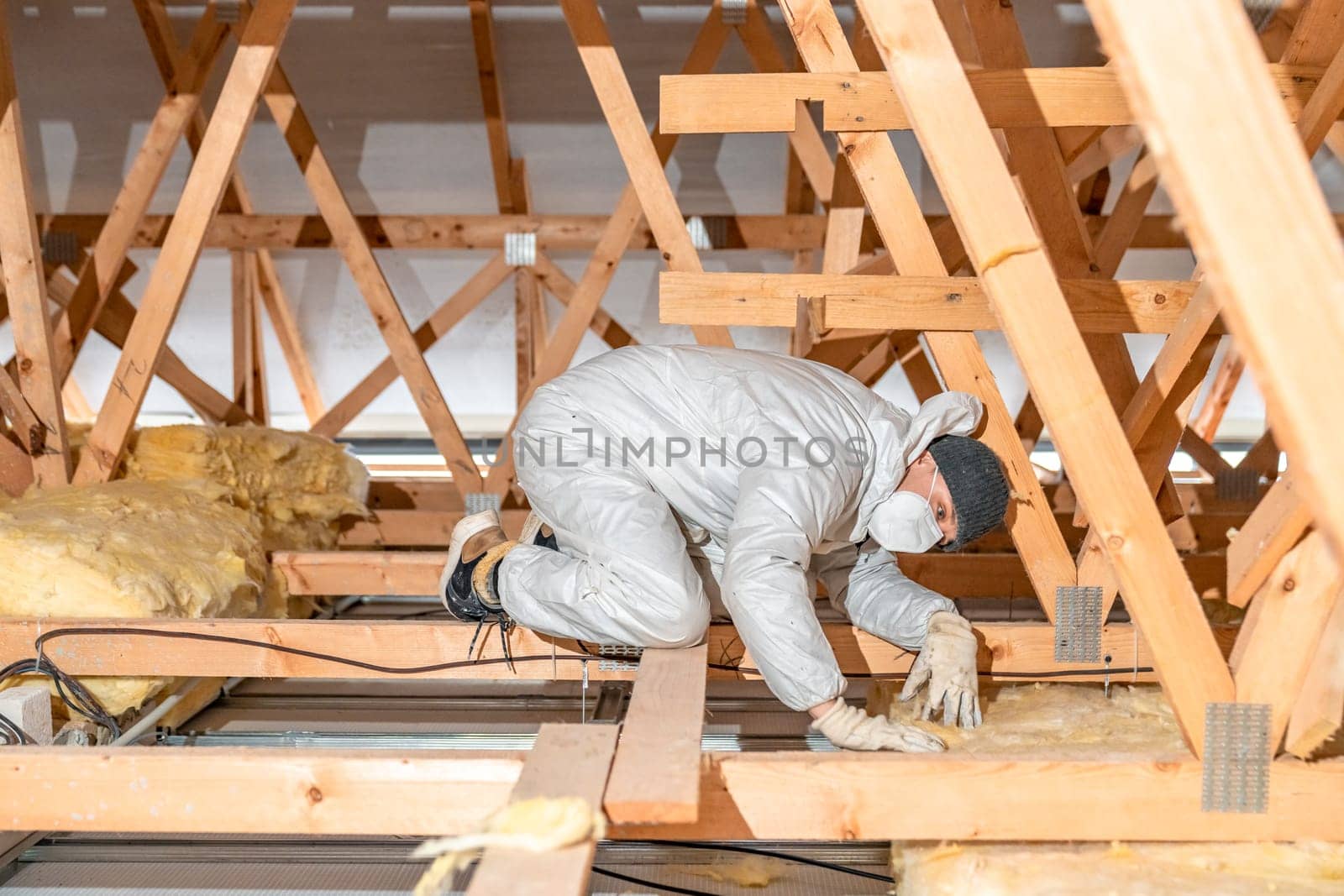 work on the attic of the house, insulated with glass wool. High quality photo