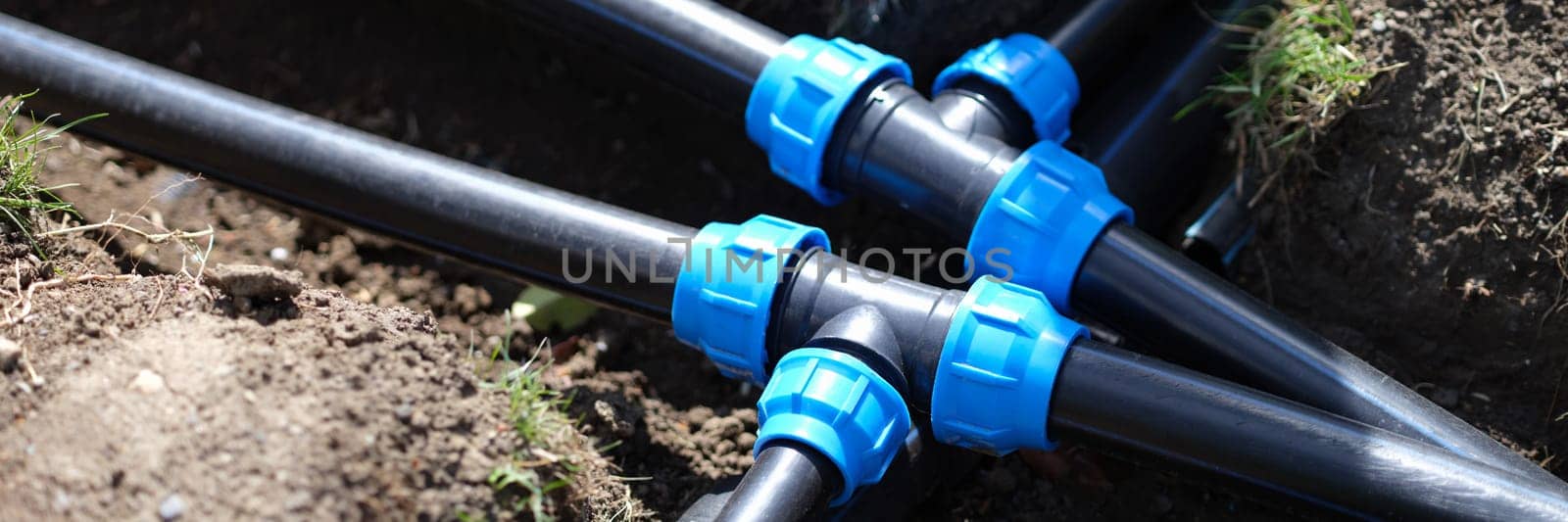 Closeup of plastic pipes of plant watering system in gardens. Gardening plant care concept