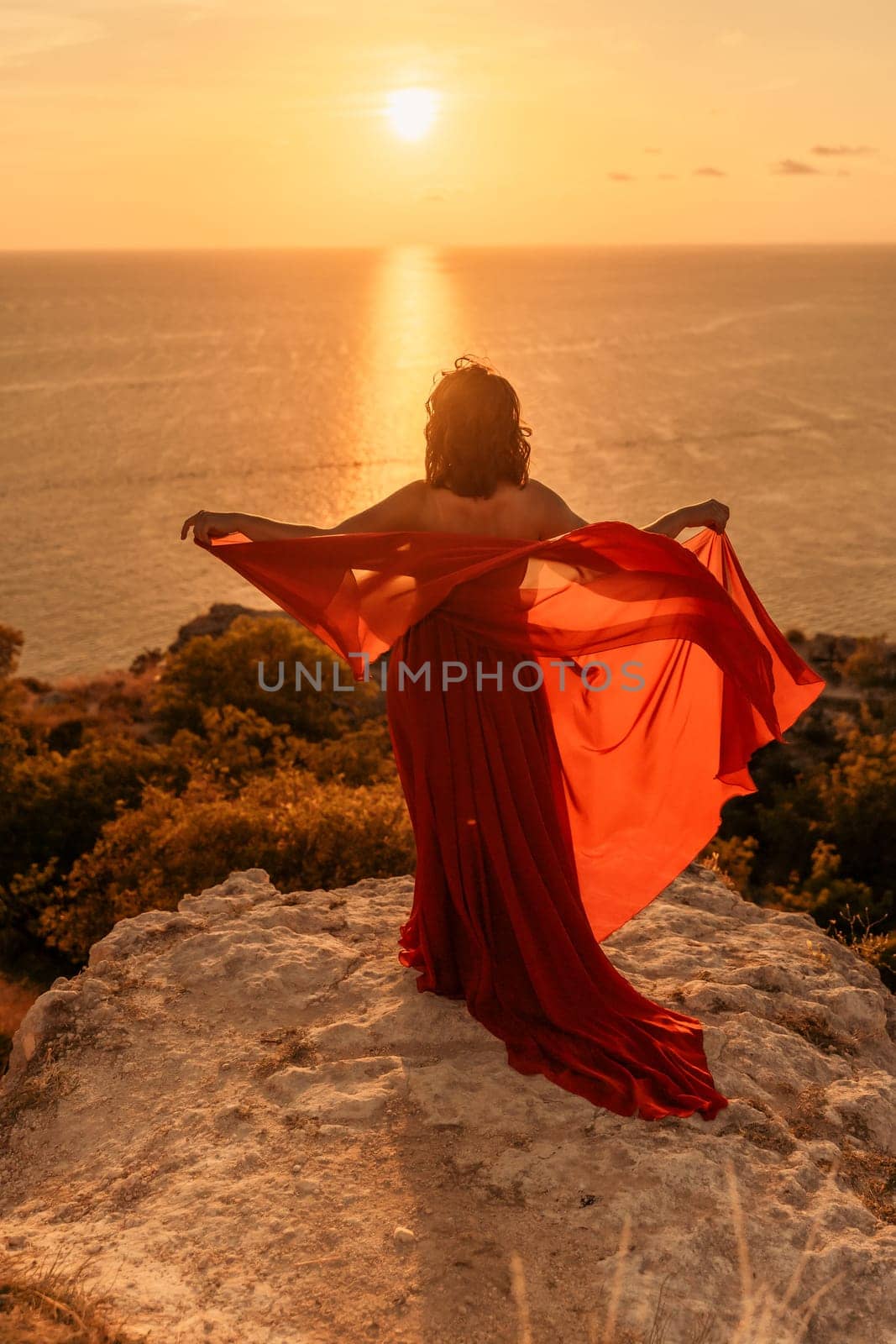 Woman in red dress, fashion model in evening dress, soaring in the street, sunset by Matiunina